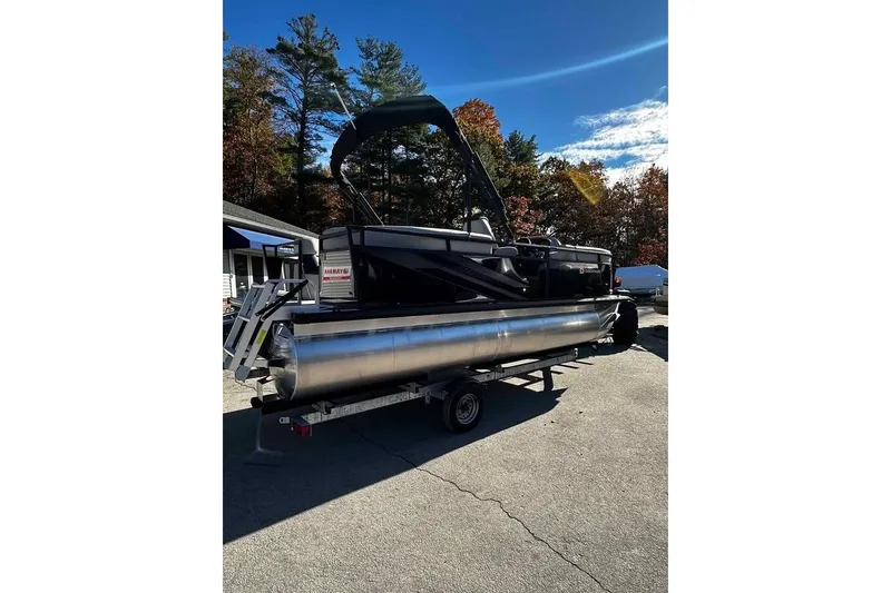 Slide: The Image of 2026 DOCKSIDE 20DQ pontoon boat on trailer, parked outdoors under clear sky. - 4