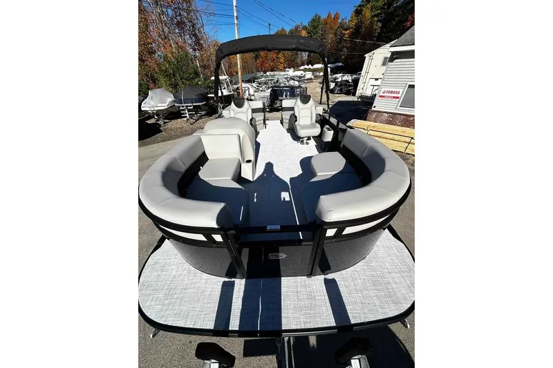 Slide: The Image of 2026 DOCKSIDE 20DQ pontoon boat with spacious seating and canopy, parked outdoors. - 6