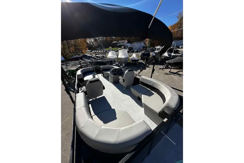 Slide: The Image of 2026 DOCKSIDE 20DQ pontoon boat with spacious seating and canopy in a sunny marina. - 7