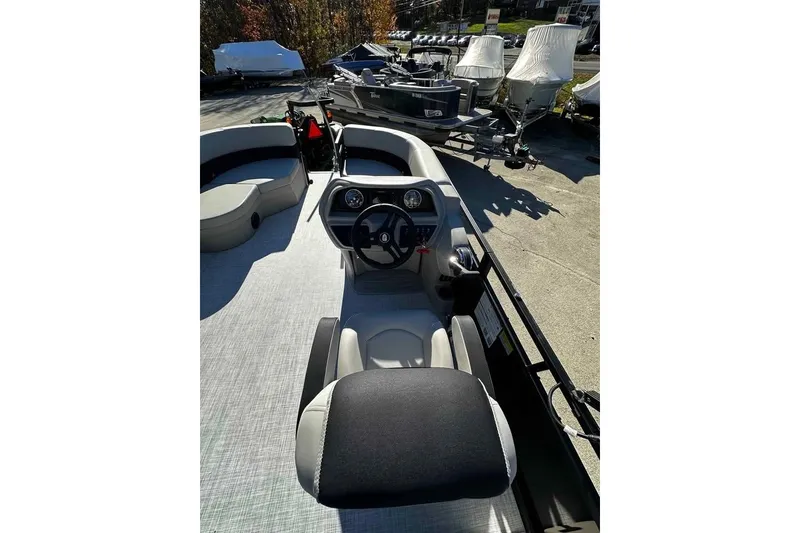 Slide: The Image of 2026 DOCKSIDE 20DQ boat interior with steering console and seating area. - 8