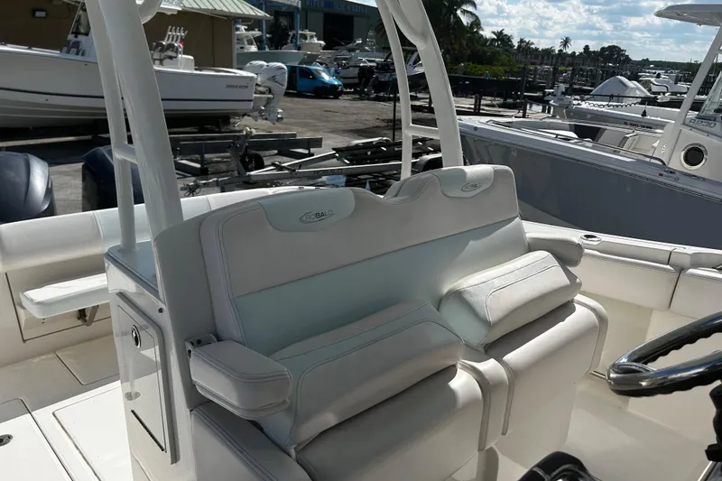 Slide: The Image of 2018 Robalo R302 Center Console boat interior with white seating and helm. - 4