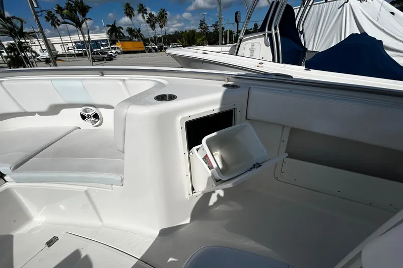 Slide: The Image of 2018 Robalo R302 Center Console boat interior with seating and storage compartment. - 8