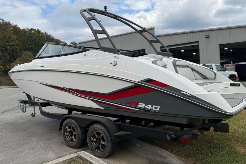 Slide: The Image of 2019 Yamaha Boats AR240 on trailer, sleek design with red and gray accents. - 2