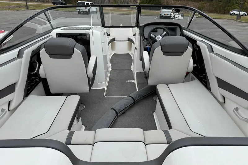 Slide: The Image of 2019 Yamaha Boats AR240 interior with sleek seating and modern dashboard design. - 4
