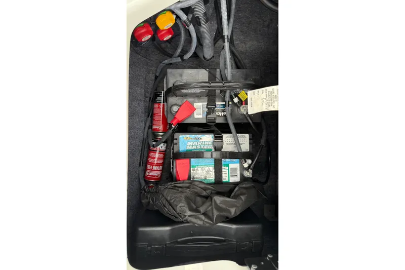 Slide: The Image of Battery compartment of a 2019 Yamaha Boats AR240 with wiring and accessories. - 8