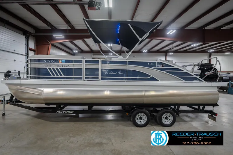 Slide: The Image of 2024 Bennington 23 LSB pontoon boat in showroom, featuring sleek design and modern amenities. - 11