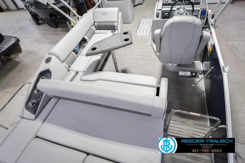 Slide: The Image of 2024 Bennington 23 LSB pontoon boat interior with gray seating and helm. - 14