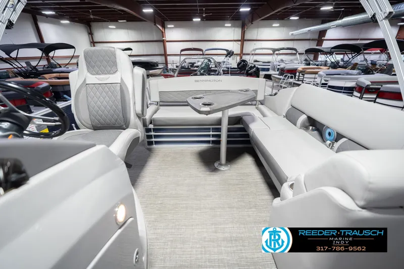 Slide: The Image of 2024 Bennington 23 LSB pontoon boat interior with luxurious seating and table setup. - 17