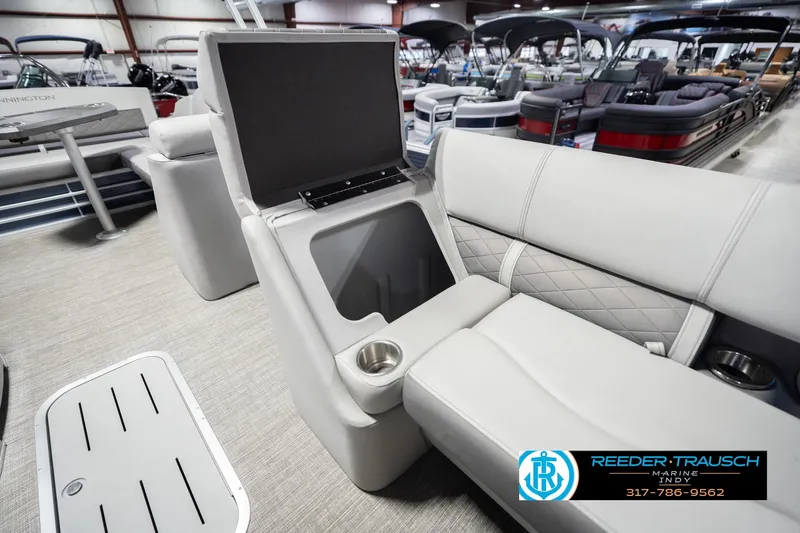 Slide: The Image of 2024 Bennington 23 LSB pontoon boat interior with storage compartment and cup holder. - 24