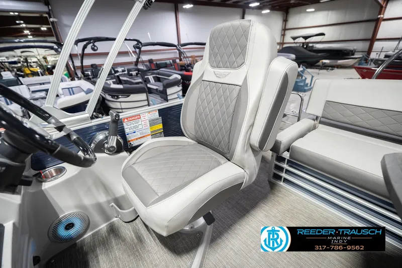 Slide: The Image of 2024 Bennington 23 LSB boat interior with luxury seating and steering wheel. - 25