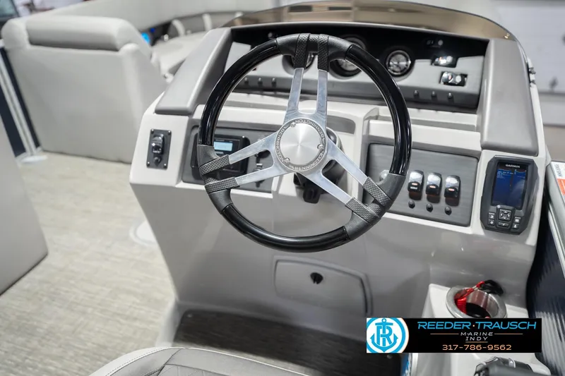 Slide: The Image of 2024 Bennington 23 LSB boat dashboard with steering wheel and control panel. - 32