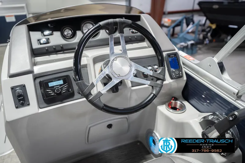 Slide: The Image of 2024 Bennington 23 LSB boat dashboard with steering wheel and control panel. - 33