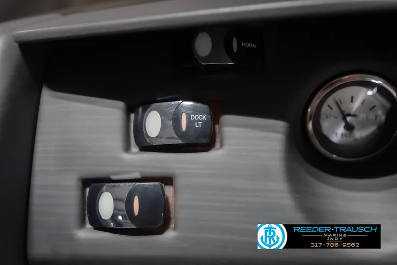 Slide: The Image of Dashboard controls of 2024 Bennington 23 LSB boat with dock light switch and gauge. - 37