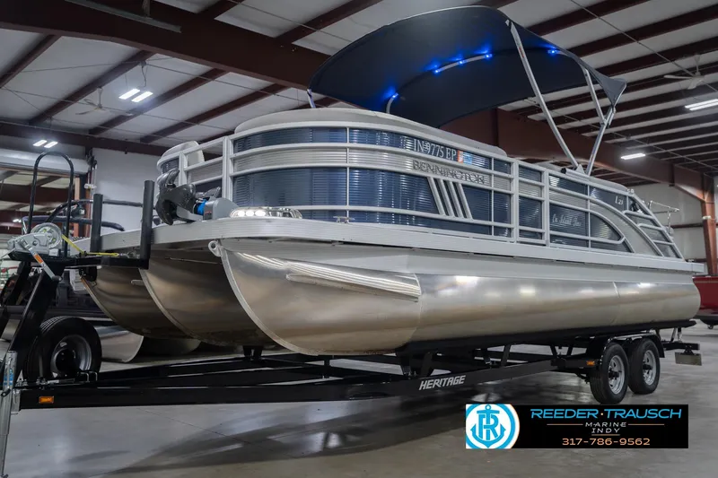 Slide: The Image of 2024 Bennington 23 LSB pontoon boat on trailer in indoor showroom. - 4