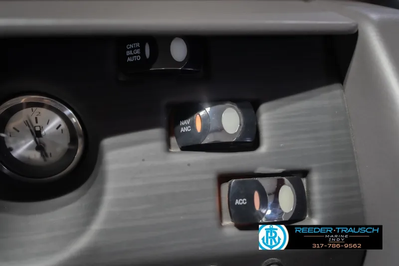 Slide: The Image of Dashboard controls of 2024 Bennington 23 LSB boat with clock and switches. - 41