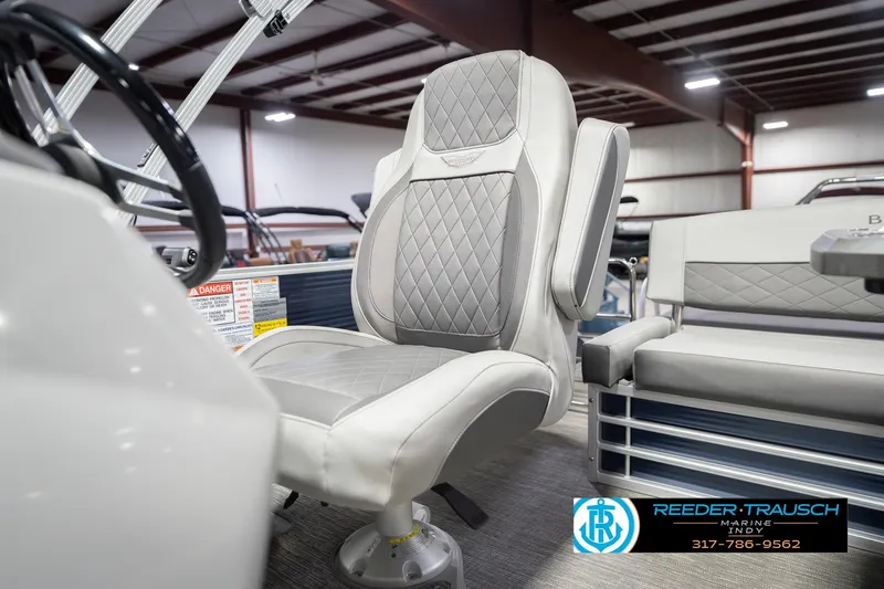 Slide: The Image of 2024 Bennington 23 LSB boat interior with luxurious seating in a showroom. - 45