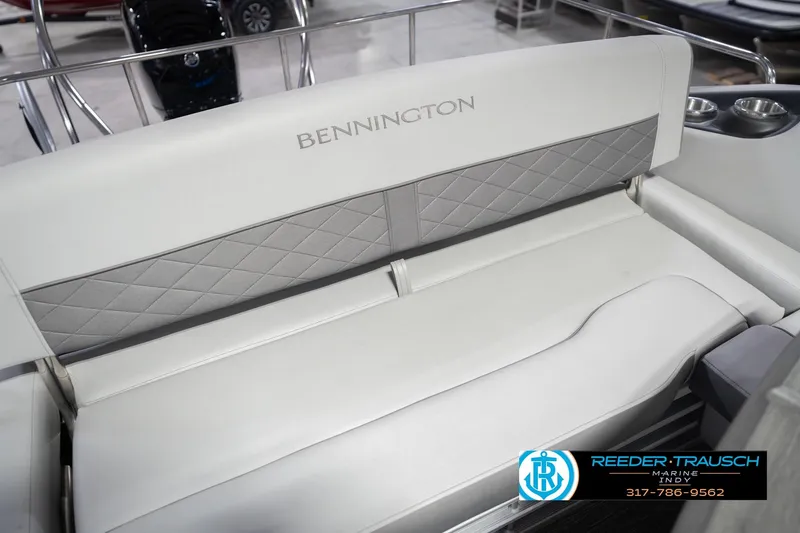 Slide: The Image of 2024 Bennington 23 LSB boat seat with diamond-patterned upholstery and cup holders. - 47