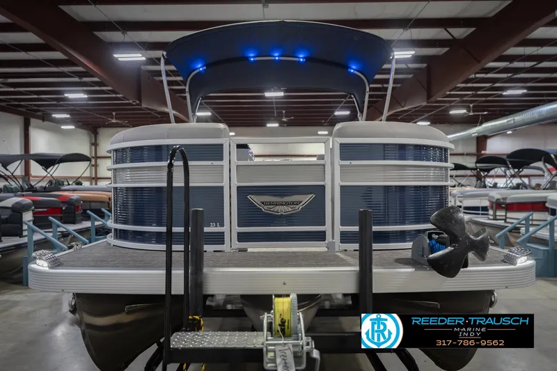 Slide: The Image of 2024 Bennington 23 LSB pontoon boat in showroom with blue LED lights. - 5