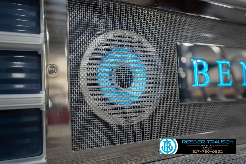 Slide: The Image of 2024 Bennington 23 LSB boat speaker with illuminated logo and Reeder Trausch Marine branding. - 52