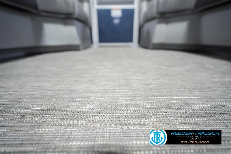 Slide: The Image of 2024 Bennington 23 LSB boat interior flooring, featuring textured design and Reeder-Trausch Marine logo. - 54
