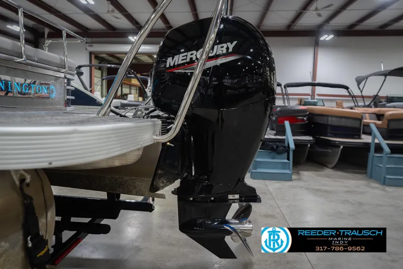 Slide: The Image of 2024 Bennington 23 LSB boat with Mercury outboard motor in showroom. - 55