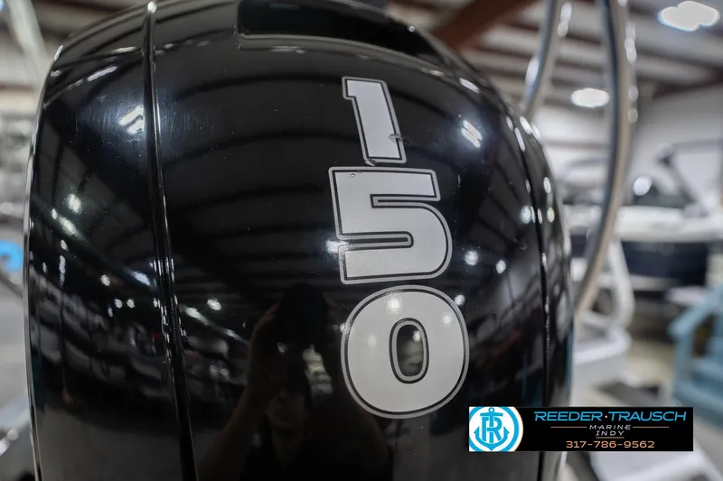 Slide: The Image of 2024 Bennington 23 LSB boat engine with "150" horsepower label in showroom. - 58
