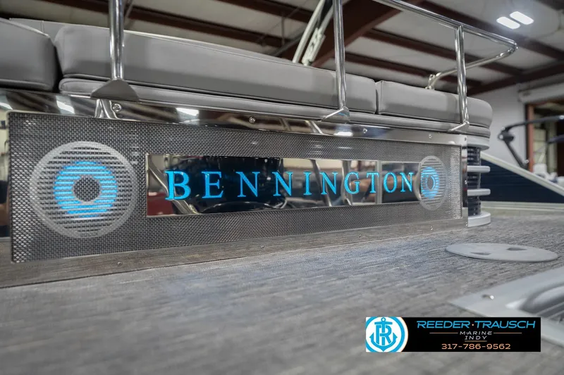 Slide: The Image of 2024 Bennington 23 LSB pontoon boat with illuminated logo and seating. - 63