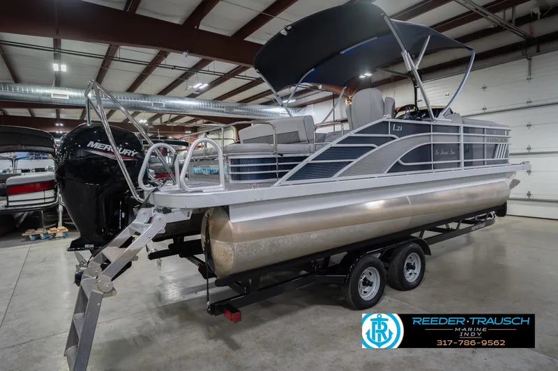 Slide: The Image of 2024 Bennington 23 LSB pontoon boat on trailer in indoor showroom. - 8