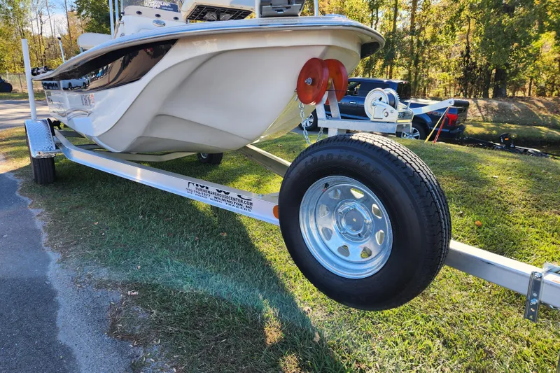 Slide: The Image of 2018 Carolina Skiff 18 JVX CC on trailer, parked on grass, sunny day. - 7