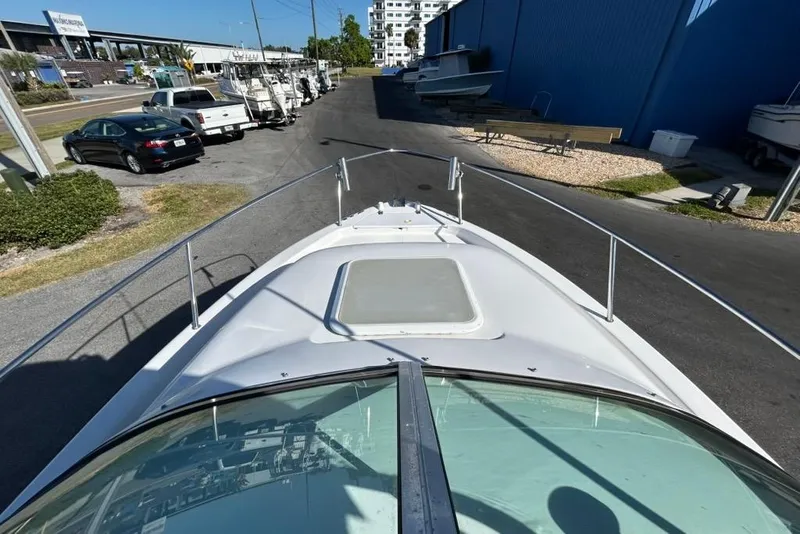 Slide: The Image of 2002 Pro-Line 22 Walk boat parked near other vehicles and boats in a marina. - 11