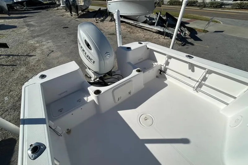 Slide: The Image of 2002 Pro-Line 22 Walk boat with Suzuki outboard motor, spacious deck view. - 13