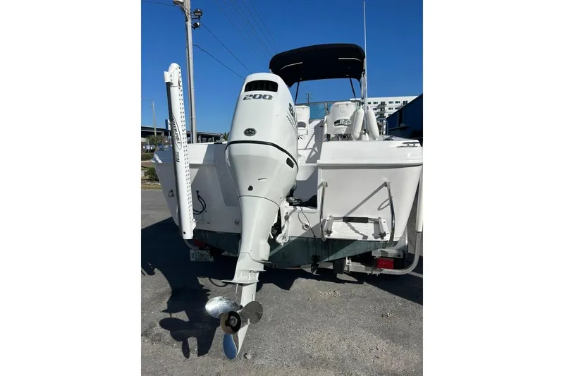 Slide: The Image of 2002 Pro-Line 22 Walk boat with powerful outboard motor, parked on a trailer. - 6