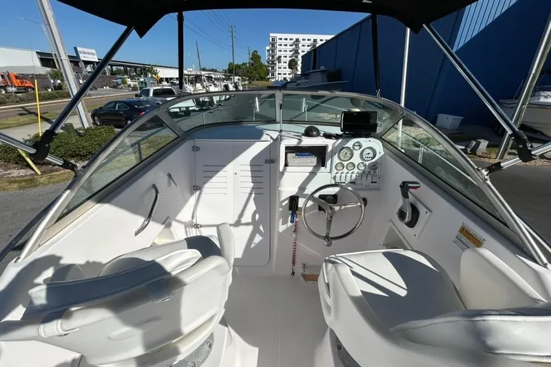 Slide: The Image of 2002 Pro-Line 22 Walk boat interior with steering wheel and dashboard controls. - 8