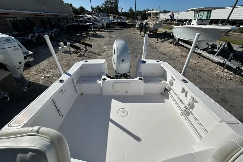 Slide: The Image of 2002 Pro-Line 22 Walk boat interior with outboard motor, parked in a marina. - 9
