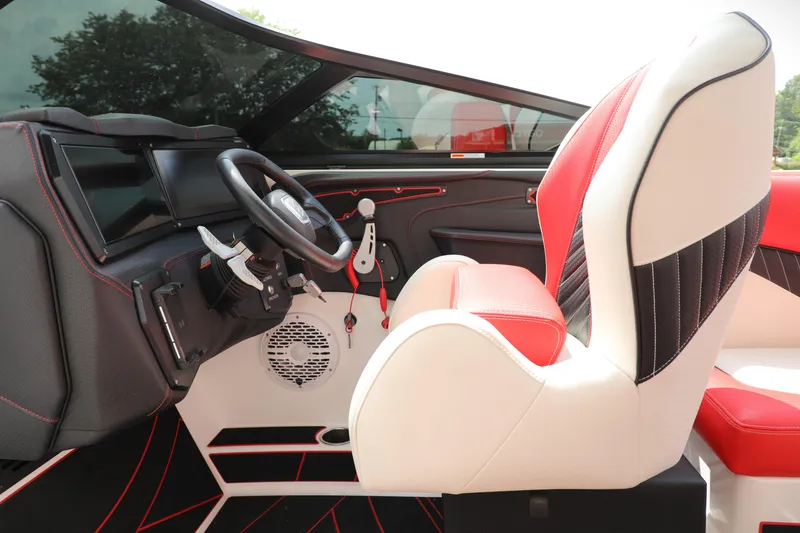 Slide: The Image of 2023 Centurion Fi25 boat interior with red and white seating, modern dashboard, and steering wheel. - 12