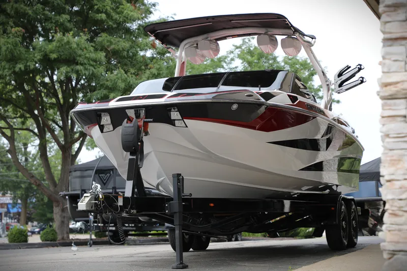 Slide: The Image of 2023 Centurion Fi25 boat on trailer, sleek design, parked outdoors. - 15