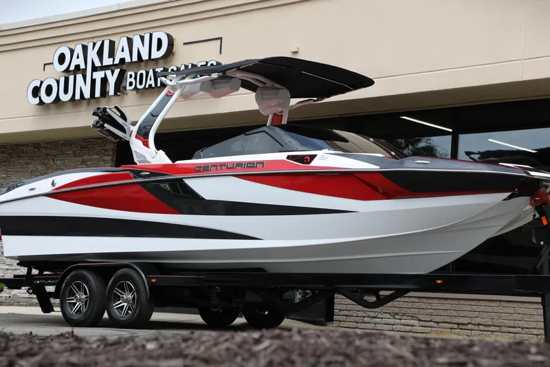 Slide: The Image of 2023 Centurion Fi25 boat in red, black, and white at Oakland County Boat Sales. - 16
