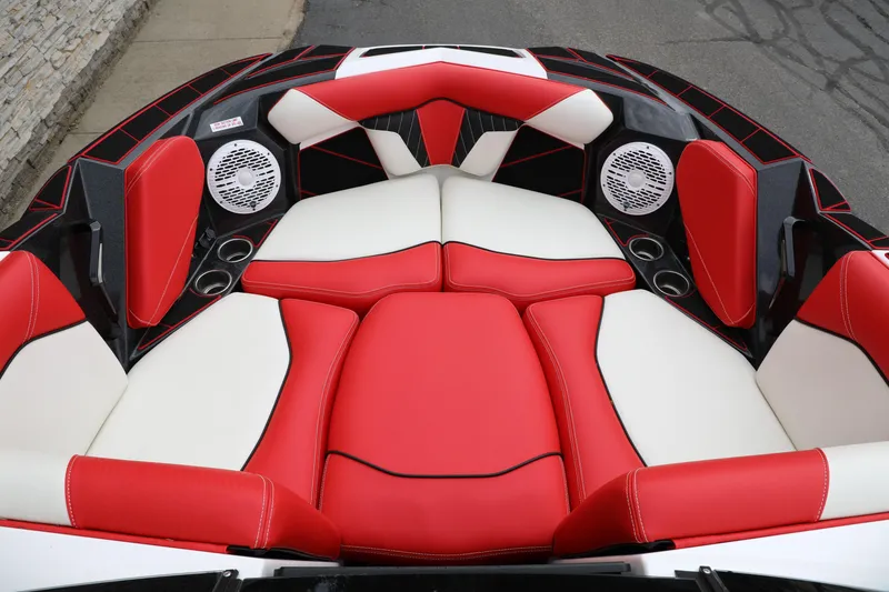 Slide: The Image of 2023 Centurion Fi25 boat interior with red and white seating, cup holders, and speakers. - 5