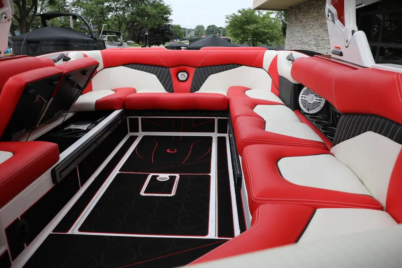 Slide: The Image of 2023 Centurion Fi25 boat interior with red and white seating, open storage compartments. - 6