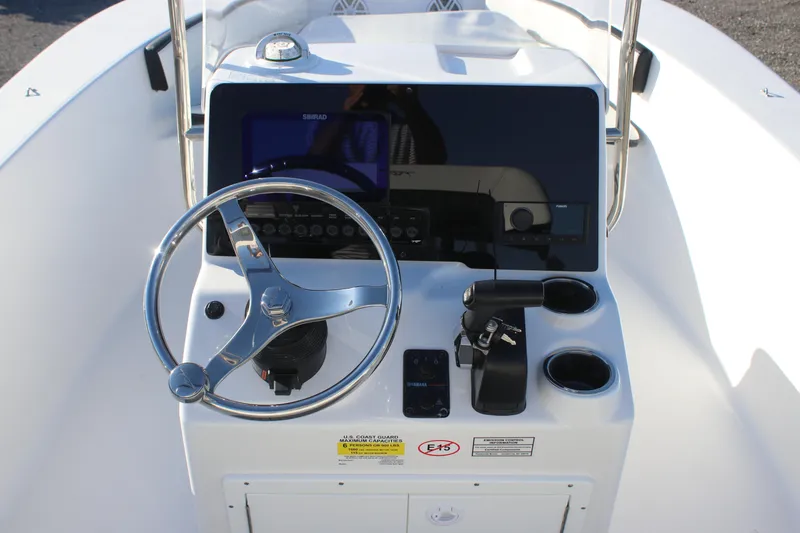 Slide: The Image of 2026 Tidewater 180 CC Adventure boat console with steering wheel and controls. - 13