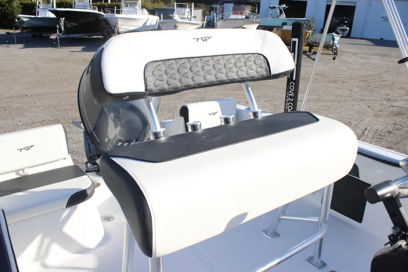 Slide: The Image of 2026 Tidewater 180 CC Adventure boat interior with cushioned seating and steering console. - 15