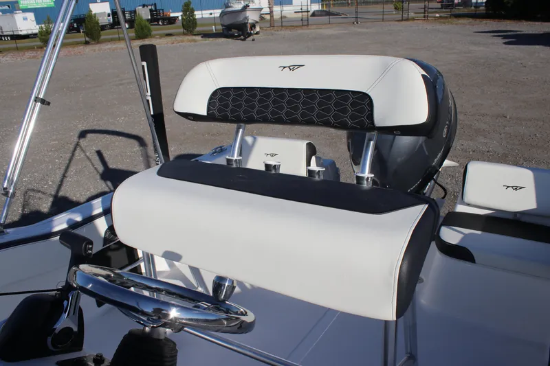 Slide: The Image of 2026 Tidewater 180 CC Adventure boat interior with steering wheel and seating. - 22