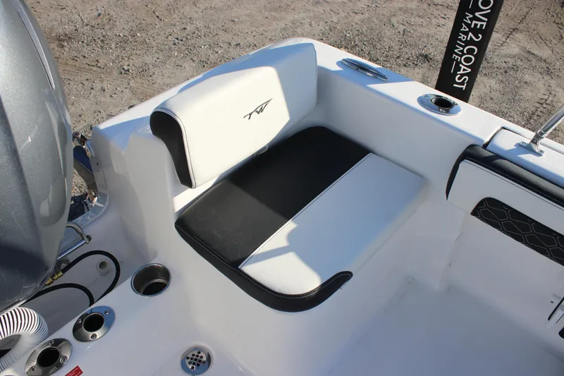 Slide: The Image of 2026 Tidewater 180 CC Adventure boat seating area with black and white upholstery. - 23