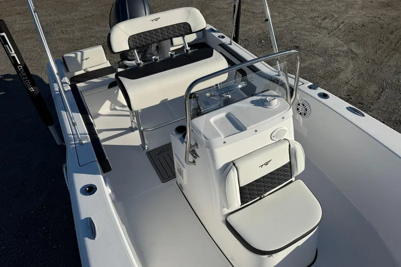 Slide: The Image of 2026 Tidewater 180 CC Adventure boat interior with seating and console, featuring sleek design elements. - 7