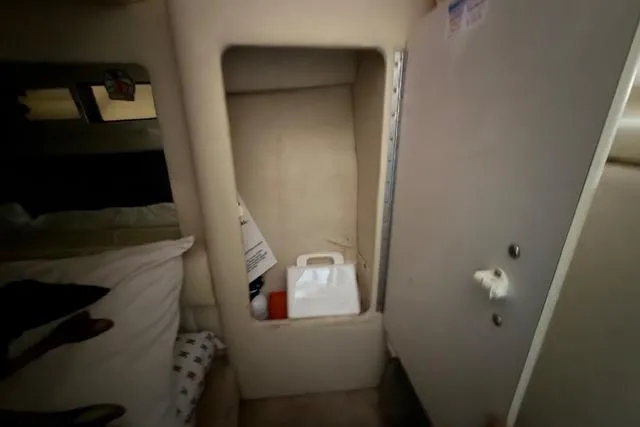 Slide: The Image of 1999 Sea Ray 270 Sundancer Special Edition cabin storage area with open door. - 21