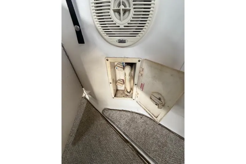 Slide: The Image of 1999 Sea Ray 270 Sundancer Special Edition interior with speaker and open compartment. - 26