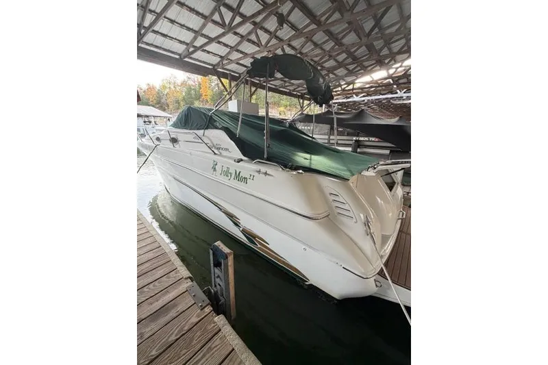 Slide: The Image of 1999 Sea Ray 270 Sundancer Special Edition docked under a covered marina. - 3
