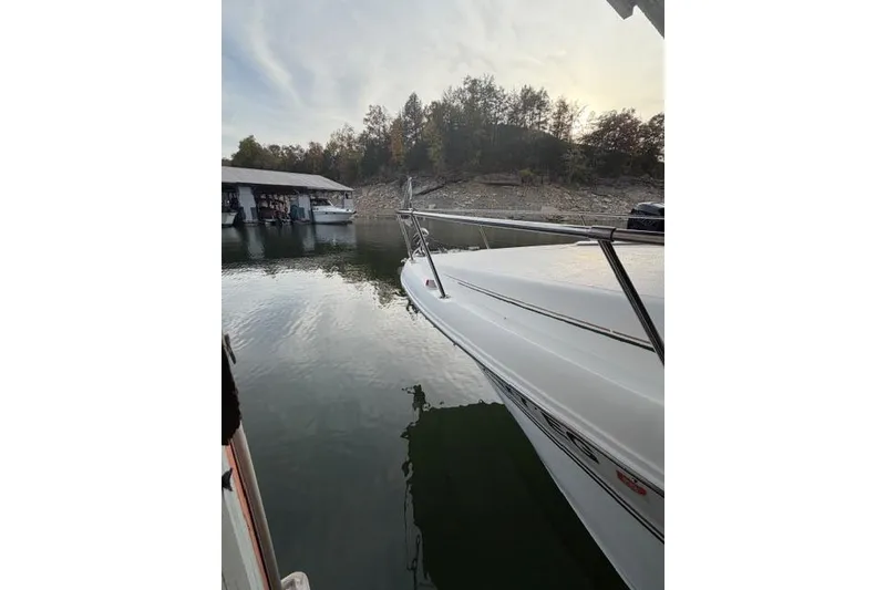 Slide: The Image of 1999 Sea Ray 270 Sundancer Special Edition docked on calm water. - 4