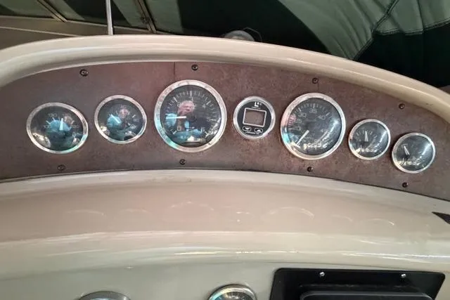 Slide: The Image of 1999 Sea Ray 270 Sundancer Special Edition dashboard with gauges and controls. - 7
