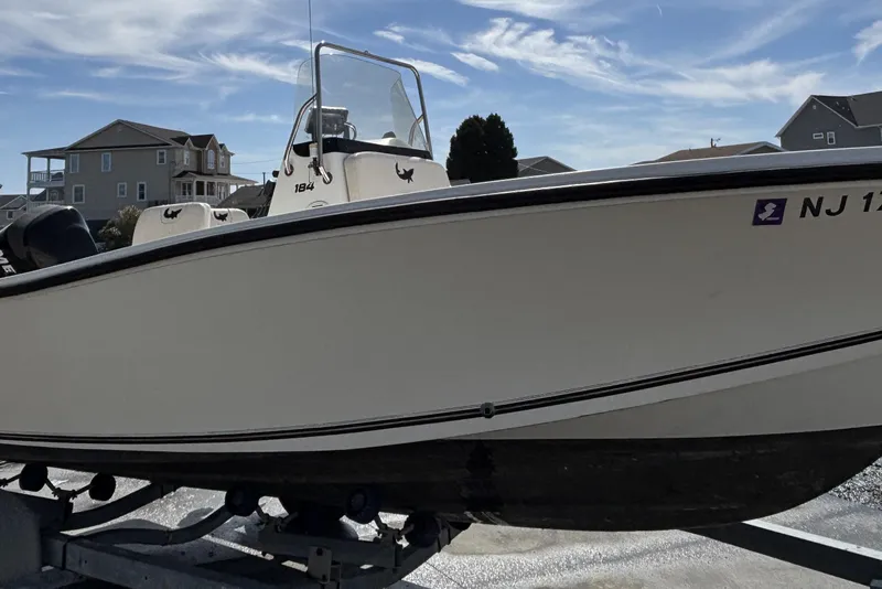 Slide: The Image of 2010 Mako 184 Center Console boat on trailer under clear sky. - 2